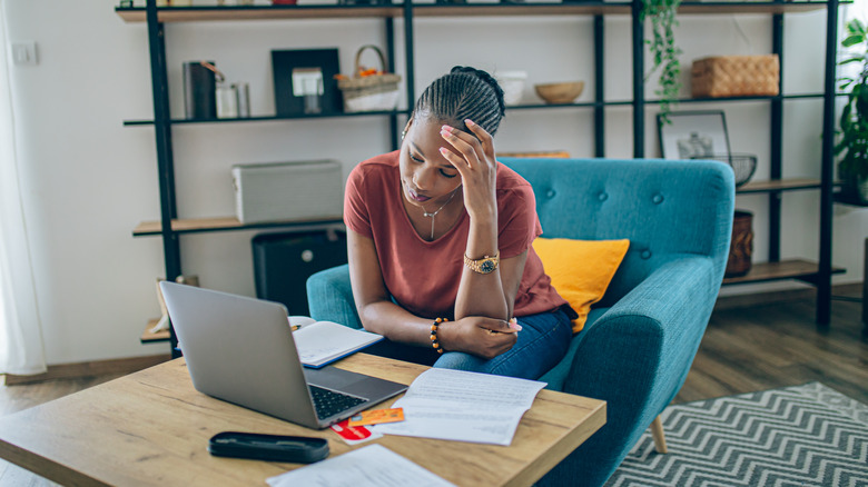 a woman stressing about her bills