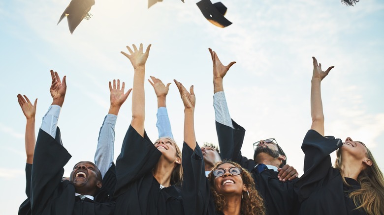 graduates throwing their caps