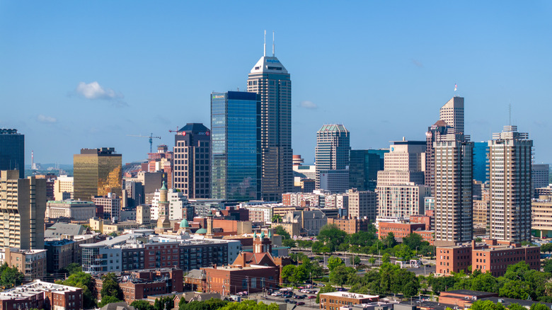 Tight drone shot of modern skyscrapers and high-rises in downtown Indianapolis, Indiana on a clear summer morning.