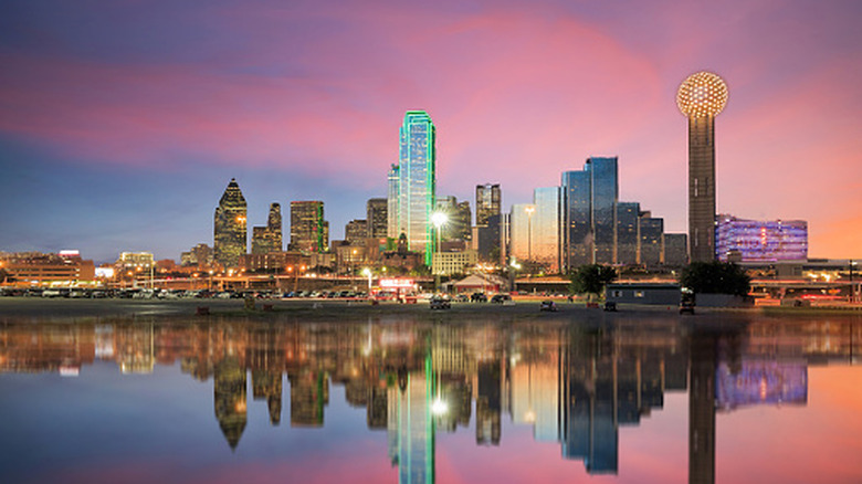 Dallas skyline reflected in Trinity river at sunset in Texas.