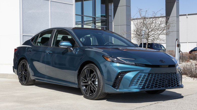 A blue Toyota Camry at a dealership.