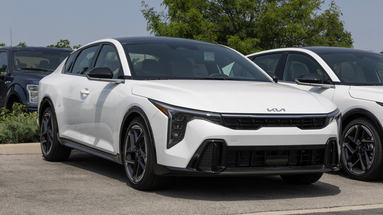 A Kia K4 GT-Line Compact Sedan display at a dealership.