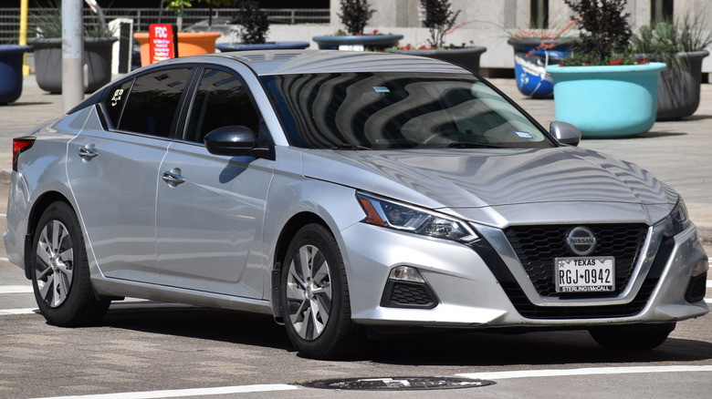 A Nissan Altima cruising in the downtown financial district of Houston.