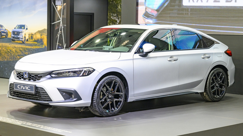 A white Honda Civic hatchback car on display.