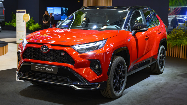 A red Toyota RAV4 on display at a car show.