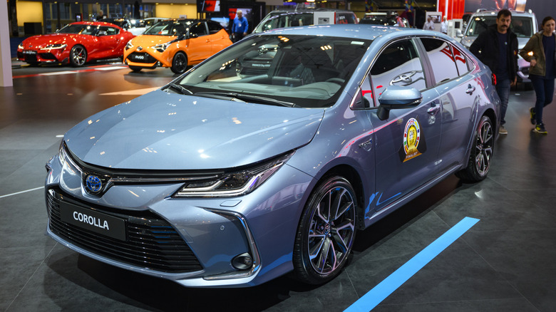 A blue Toyota Corolla compact hatchback sedan on display.