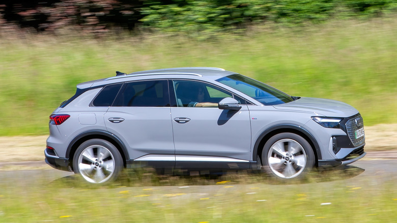 A grey Audi Q4 e-tron s line 40 electric car driving on a country road