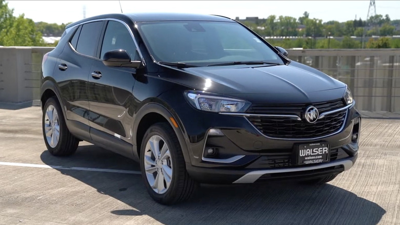 A black 2022 Buick Encore GX on a parking garage roof on a sunny day
