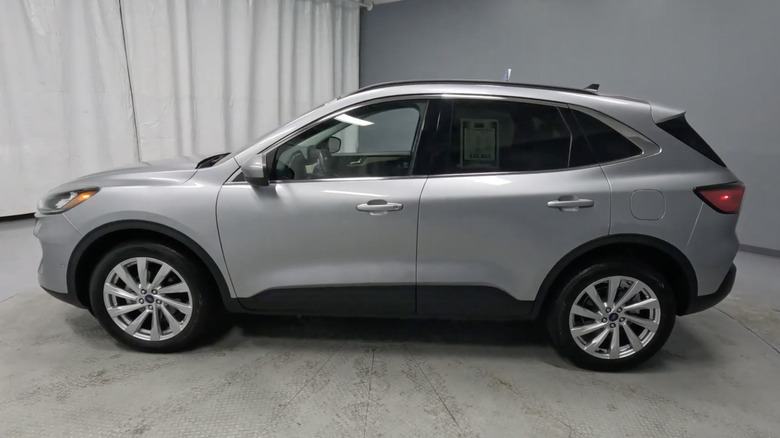 A silver Ford Escape Titanium on display in a gray room