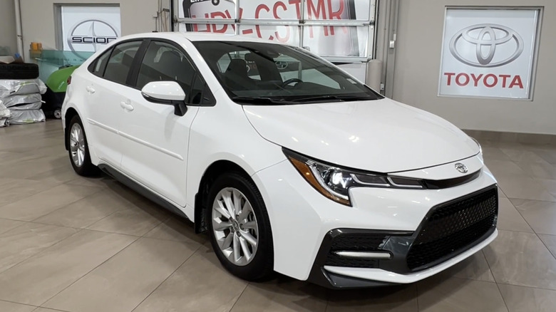 A white 2022 Toyota Corolla SE on a dealership floor