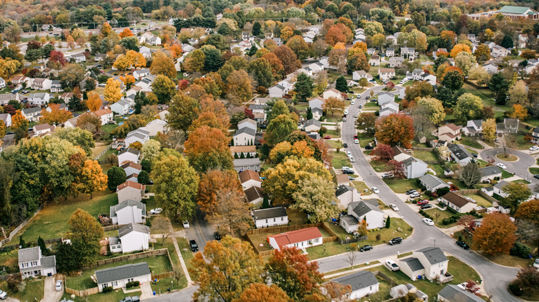 Helicopter shot of residential streets in Montgomery County, Maryland, north of Washington, D.C. on a hazy afternoon in Fall.