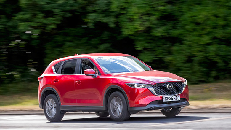 The 2025 Mazda CX-5 SUV driving on a British road.
