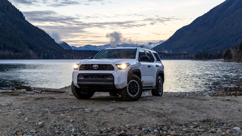 The Toyota 4Runner by a tranquil lake during dusk.