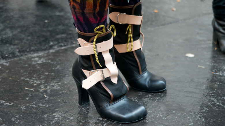 A woman wearing Vivienne Westwood Pirate boots on the street.
