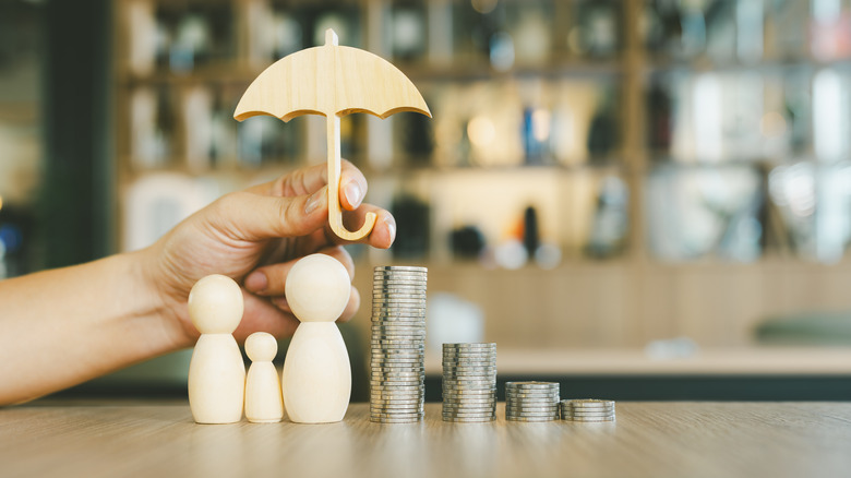 umbrella over people figurines