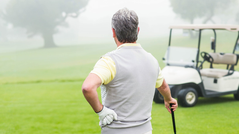 Senior man waiting on a golf course