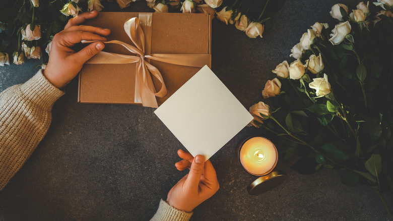 Woman holding gift card box with a bow