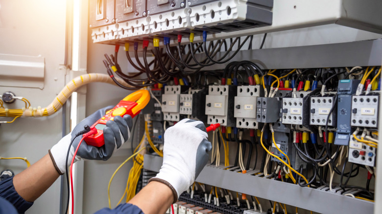 Electrician's hands servicing a building's electrical system