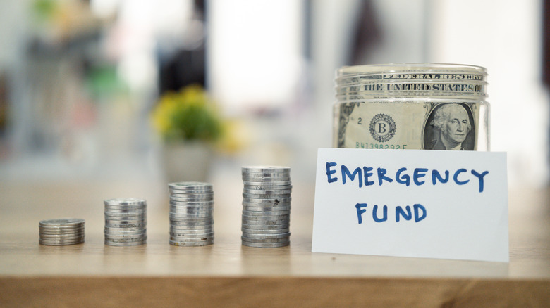 Emergency fund jar and stacks of coins