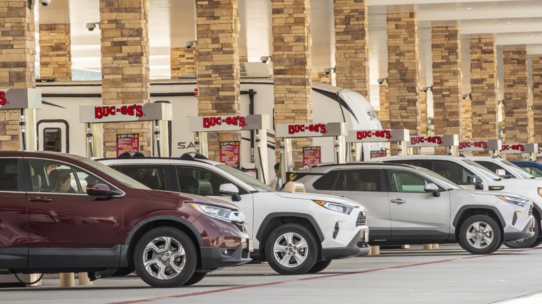 Cars lined up at fuel pumps beneath the covered forecourt of a Buc-ee's gas station