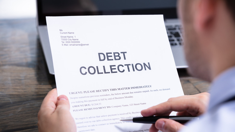Man reads a debt collection notice