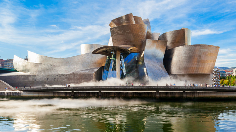 The Guggenheim Museum Bilbao with water in the foreground.