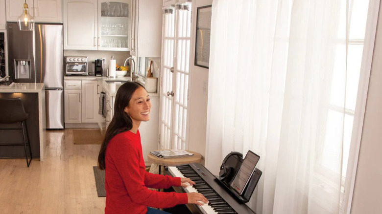 Woman playing a piano bought from Costco