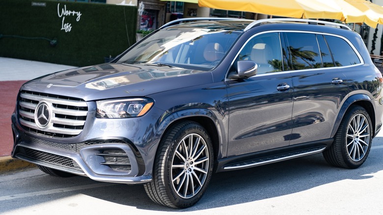 A gray Mercedes-Benz GLS SUV parked on a sunny street