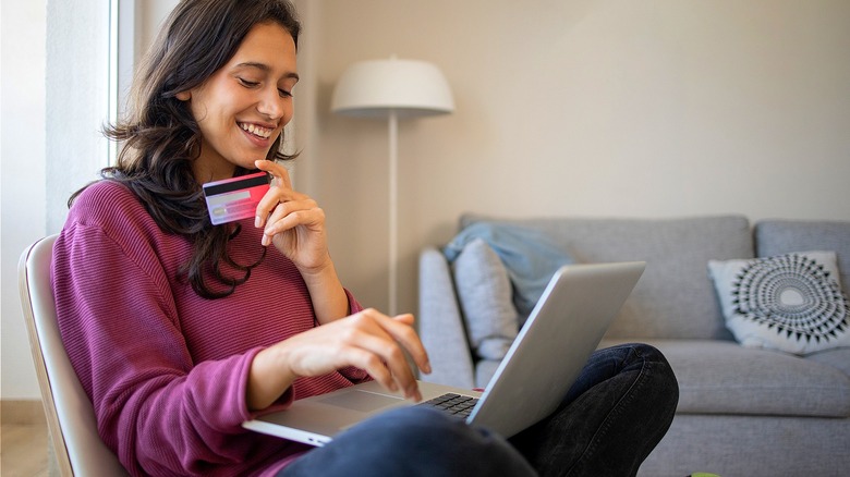 Student smiling with credit card