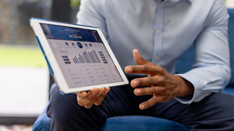 financial advisor showing financial data on tablet