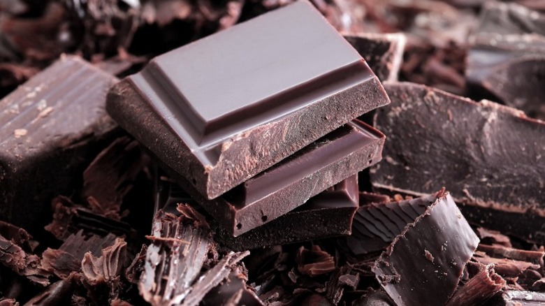 Shavings and pieces of dark chocolate in a pile.