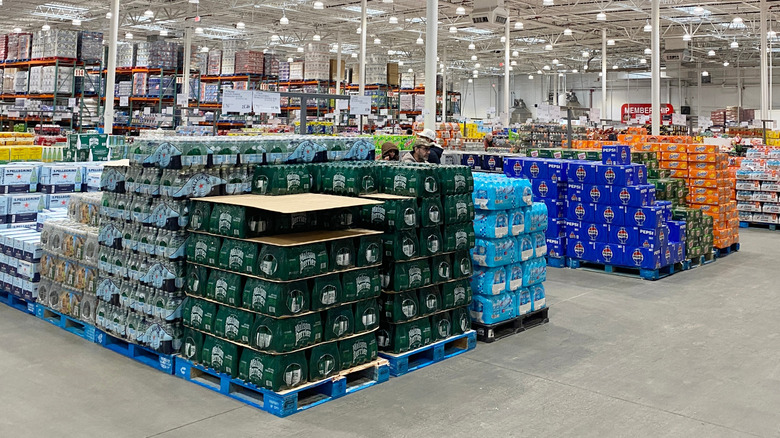 Pallets of drinks in cases inside a Costco store.