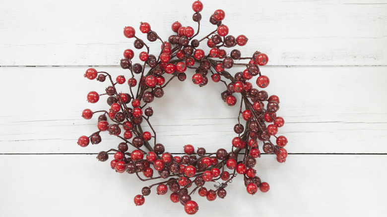 A berry Christmas wreath on wooden wall
