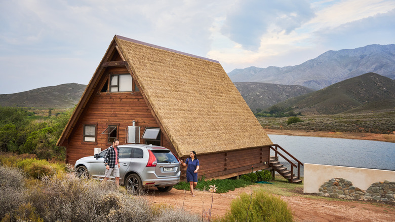 people at a cabin next to a lake
