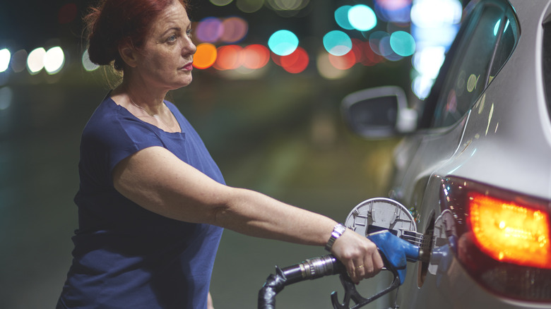 Refuelling her luxury SUV at the gas station is a costly routine