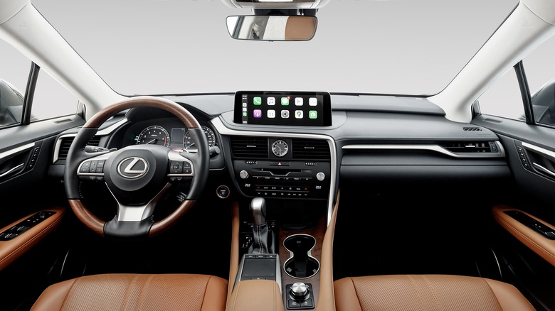 2020 Lexus RX interior with tan leather seats, wood-trimmed wheel, and Apple CarPlay on the screen