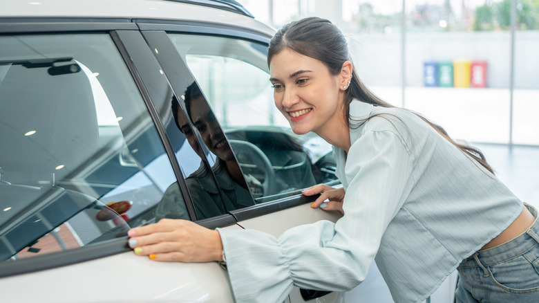 Beautiful woman loves her luxury SUV