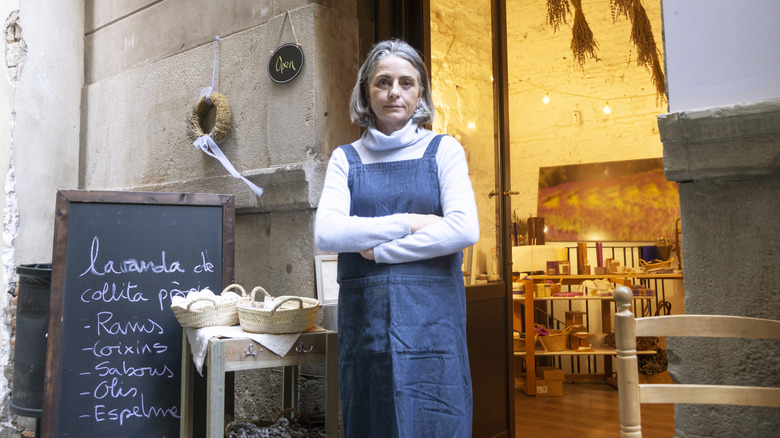 Woman standing outside lavender shop in Europe