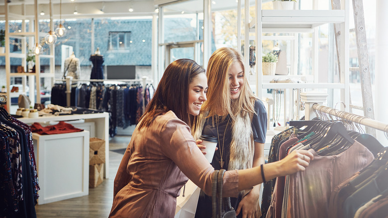 Two women shopping for clothes in a boutique