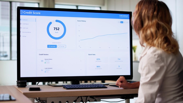 Person viewing a credit score dashboard showing a score of 752 on a computer monitor