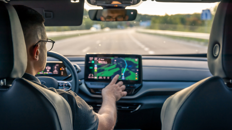 Ma touching GPS screen in car