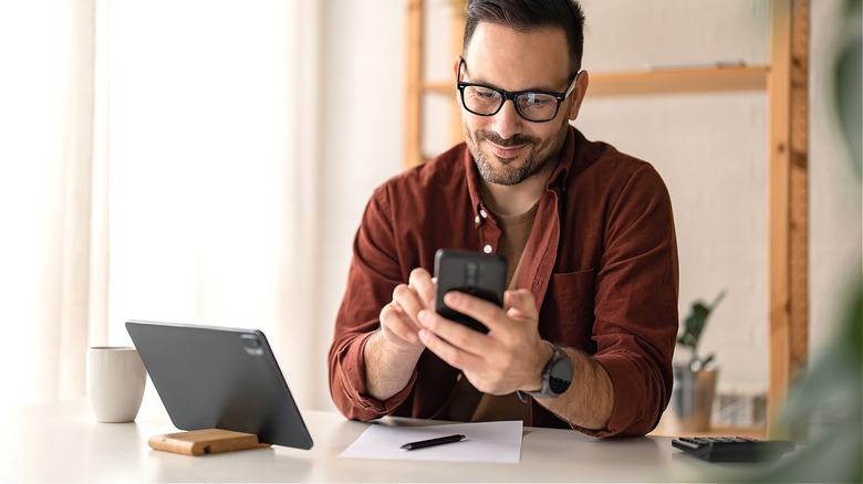 Person happy over smartphone news