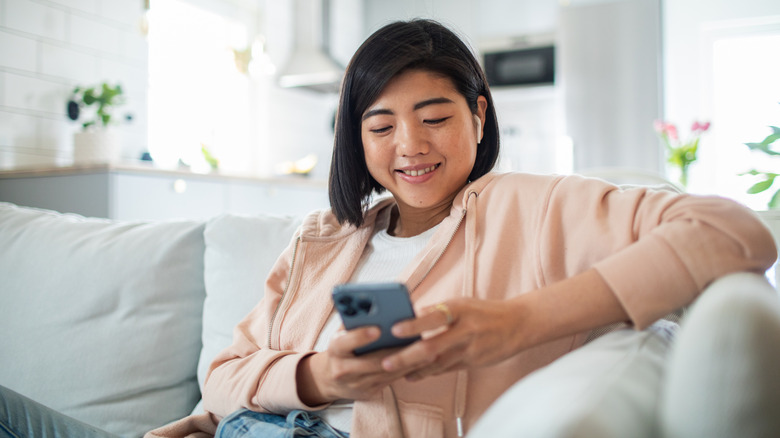 person on the phone sitting on couch