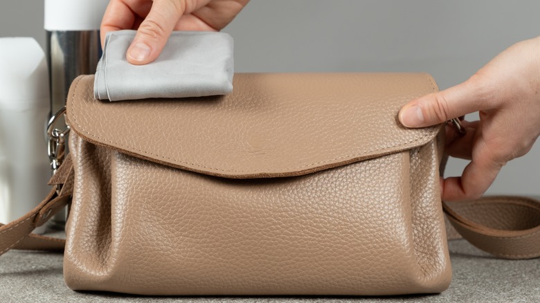 Woman works on handcrafted luxury handbag