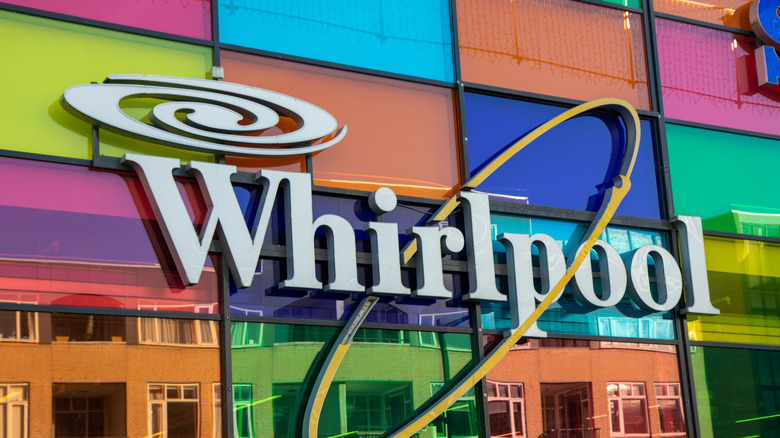 Whirlpool logo on window reflecting various colors