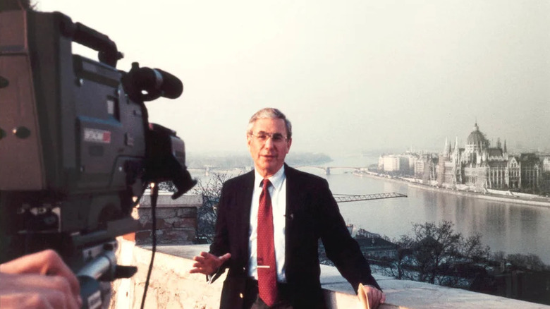 George Goodman in front of camera with Budapest in background