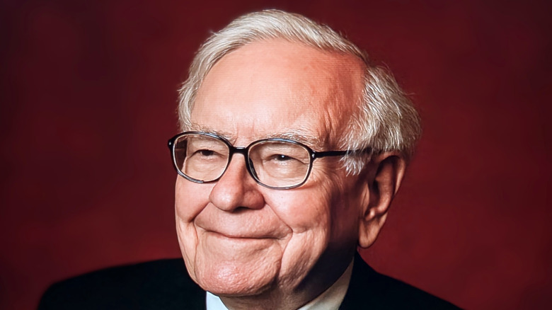 Warren Buffett smiling in a dark suit