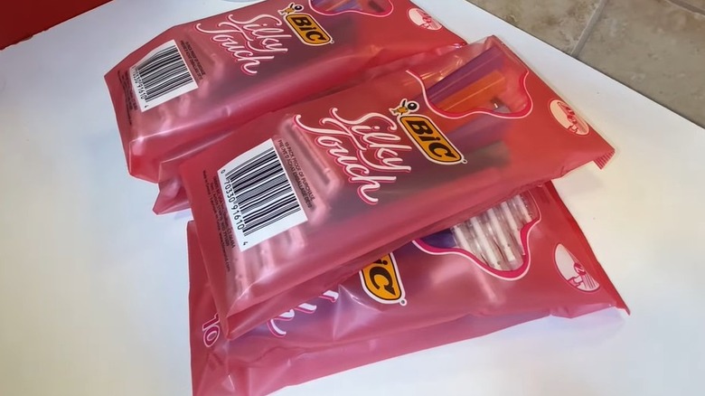 Pile of unopened bags of women's razors