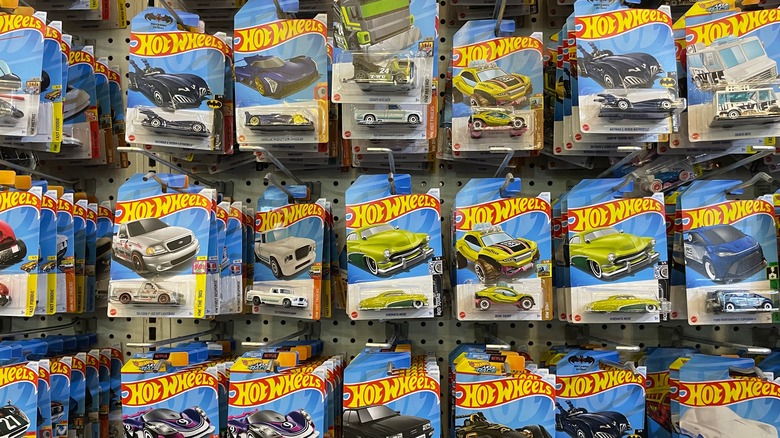 Rows of Hot Wheels toy cars hanging up in store aisle
