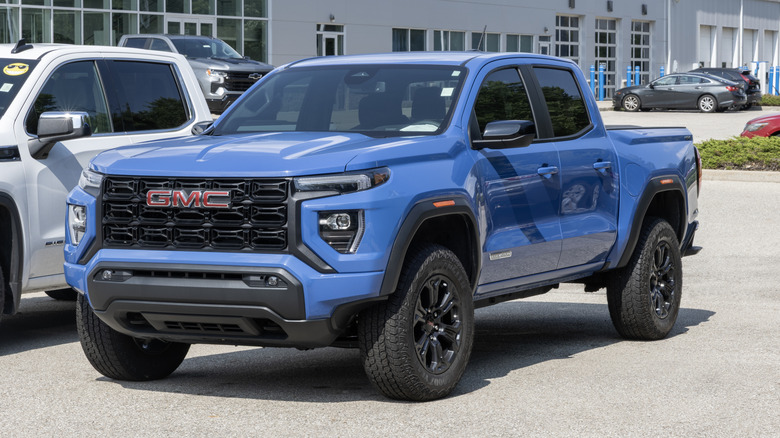 A used blue GMC Canyon at a dealership.